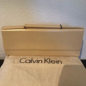 Calvin Klein Collection tan leather clutch w/ adjustable strap.